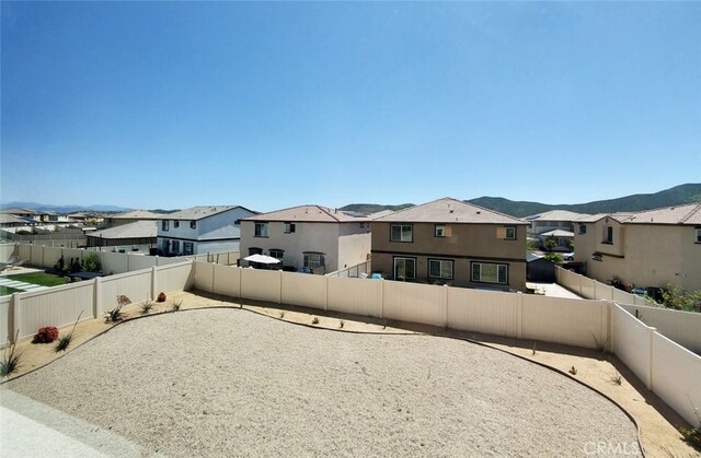 24295 Insignia Dr, Menifee, CA 92584 - fenced backyard with a residential view and a mountain view