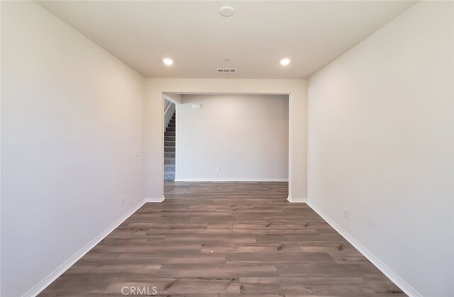 24295 Insignia Dr, Menifee, CA 92584 - hall with wood finished floors, recessed lighting, baseboards, and stairs