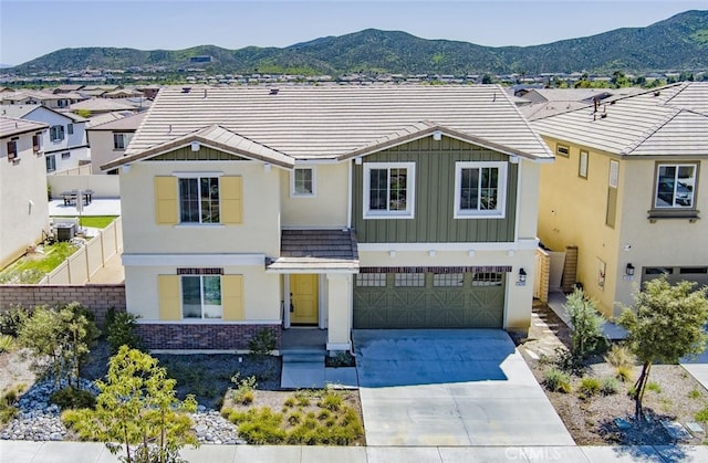 24295 Insignia Dr, Menifee, CA 92584 - view of front of house with concrete driveway, stucco siding, a mountain view, an attached garage, and board and batten siding