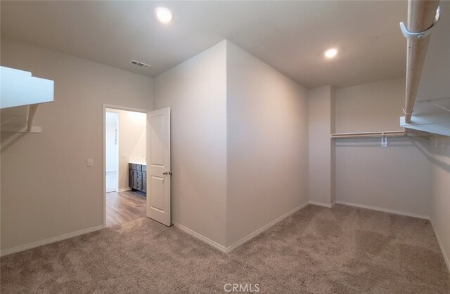 24295 Insignia Dr, Menifee, CA 92584 - walk in closet featuring carpet