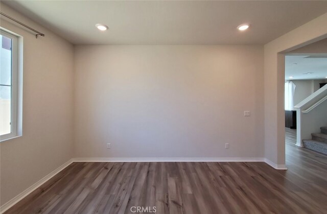 24295 Insignia Dr, Menifee, CA 92584 - spare room featuring wood finished floors, stairs, baseboards, plenty of natural light, and recessed lighting