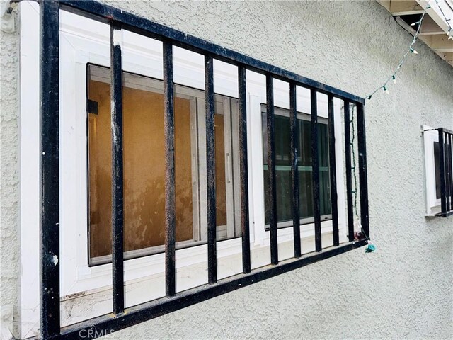 view of side of home with stucco siding
