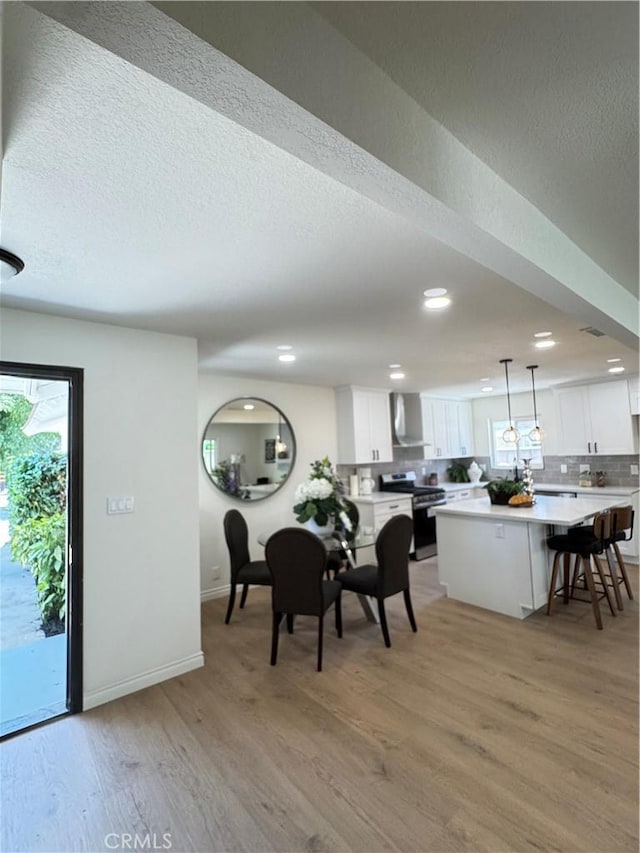 2126 S Fern Ave, Ontario, CA 91762 - dining room featuring recessed lighting, light wood-style floors, a textured ceiling, baseboards, and healthy amount of natural light