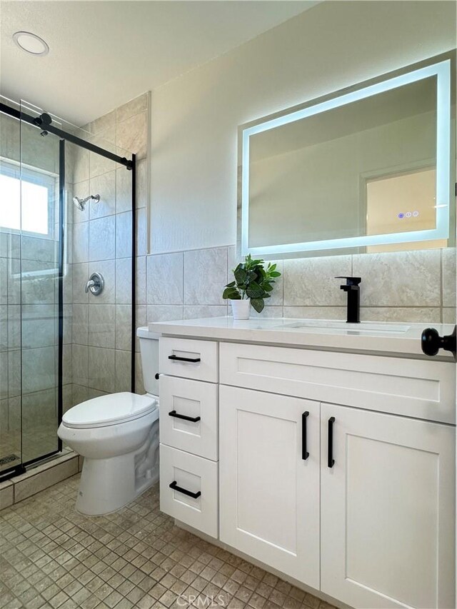 2126 S Fern Ave, Ontario, CA 91762 - full bathroom with tile walls, a shower stall, vanity, and toilet