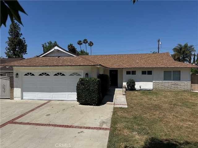 2126 S Fern Ave, Ontario, CA 91762 - ranch-style house featuring stucco siding, concrete driveway, a front lawn, an attached garage, and roof with shingles