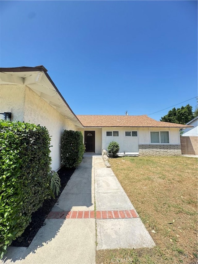 2126 S Fern Ave, Ontario, CA 91762 - view of front of house with stucco siding and a front lawn