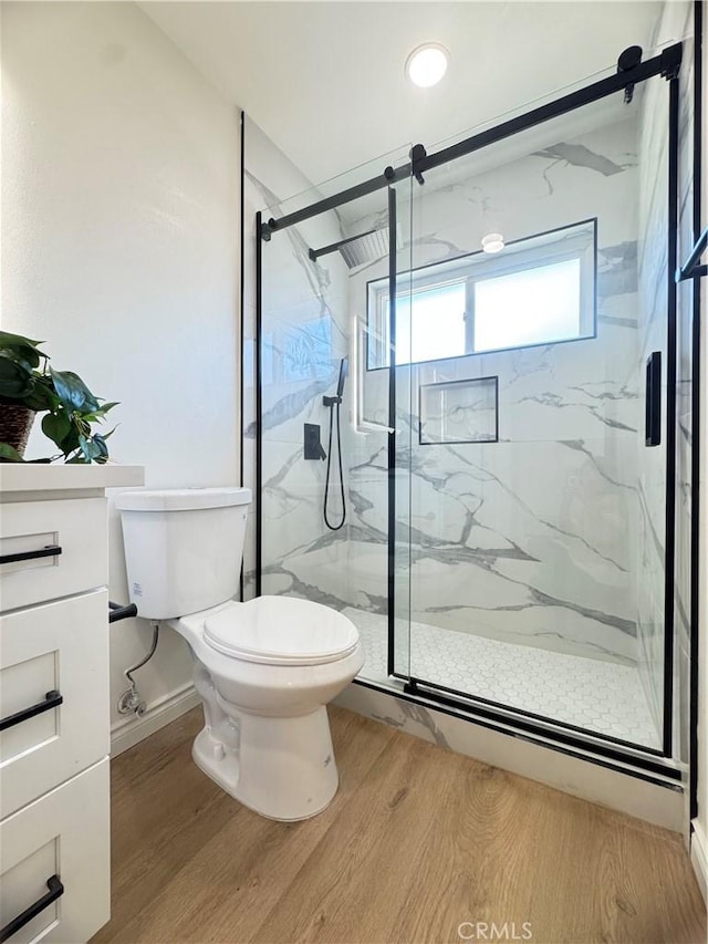 2126 S Fern Ave, Ontario, CA 91762 - bathroom with wood finished floors, toilet, a marble finish shower, and vanity