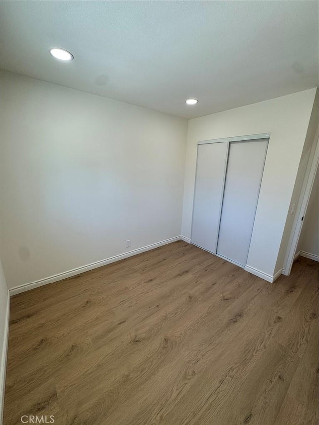 2126 S Fern Ave, Ontario, CA 91762 - unfurnished bedroom featuring wood finished floors, baseboards, recessed lighting, and a closet