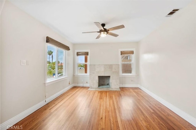 4718 Dawes St, San Diego, CA 92109 - unfurnished living room with baseboards, light wood-style floors, a ceiling fan, and a fireplace