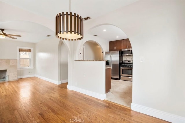 4718 Dawes St, San Diego, CA 92109 - unfurnished living room with a ceiling fan, light wood-type flooring, arched walkways, baseboards, and recessed lighting
