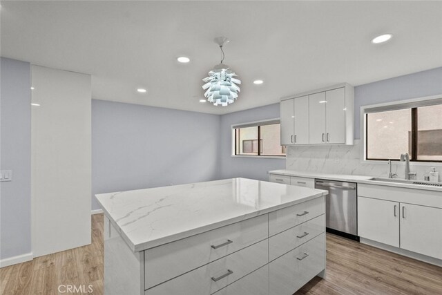 kitchen with stainless steel dishwasher, a sink, white cabinetry, recessed lighting, and light wood-style flooring