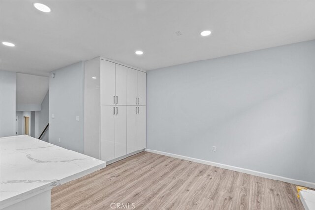 basement featuring light wood finished floors, recessed lighting, and baseboards