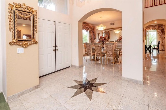 20800 Brana Rd, Riverside, CA 92508 - entryway featuring arched walkways, a towering ceiling, and a chandelier