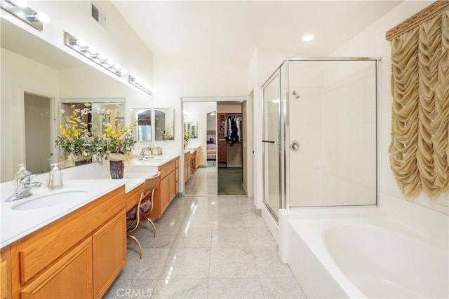 20800 Brana Rd, Riverside, CA 92508 - bathroom featuring a shower stall, double vanity, a bath, a spacious closet, and recessed lighting