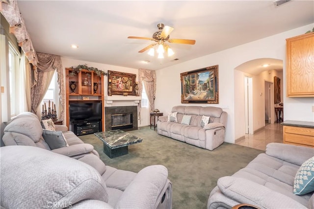 20800 Brana Rd, Riverside, CA 92508 - carpeted living area featuring arched walkways, ceiling fan, a glass covered fireplace, and recessed lighting