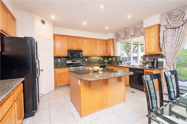 20800 Brana Rd, Riverside, CA 92508 - kitchen featuring black appliances, a center island, dark stone counters, tasteful backsplash, and recessed lighting