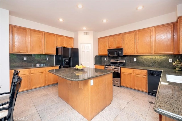 20800 Brana Rd, Riverside, CA 92508 - kitchen with black appliances, a kitchen island, tasteful backsplash, dark stone counters, and recessed lighting