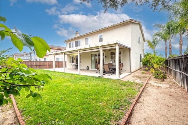 20800 Brana Rd, Riverside, CA 92508 - rear view of house with a fenced backyard, stucco siding, a patio, and a chimney