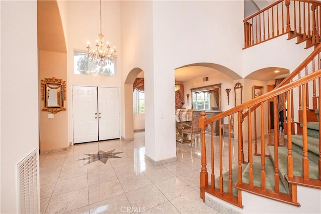 20800 Brana Rd, Riverside, CA 92508 - entryway with a high ceiling, arched walkways, stairway, and a chandelier