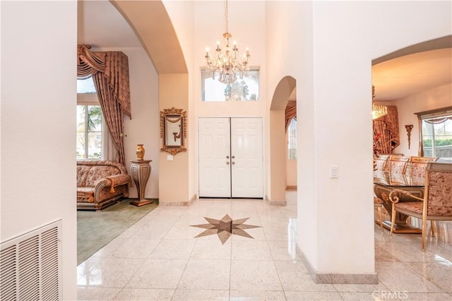 20800 Brana Rd, Riverside, CA 92508 - entryway featuring arched walkways, a chandelier, and a high ceiling