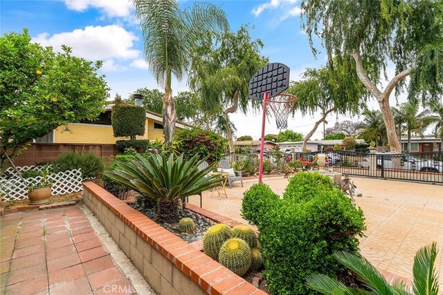 view of property's community featuring fence and community basketball court