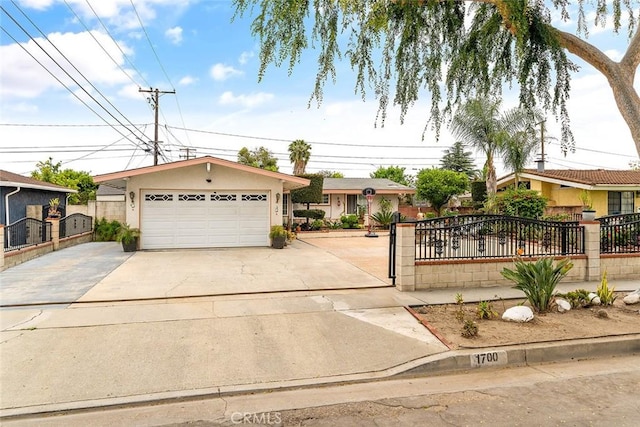 ranch-style house with a fenced front yard, a detached garage, and stucco siding
