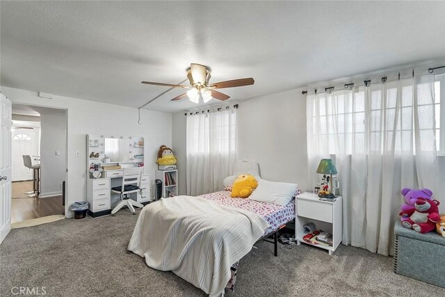 bedroom with carpet, an office area, and ceiling fan