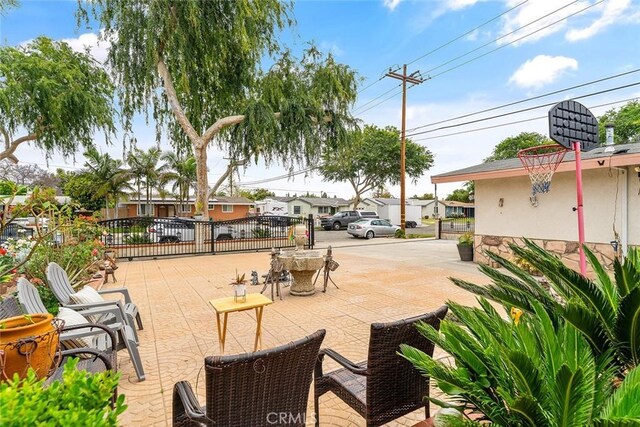 view of patio with fence and a residential view