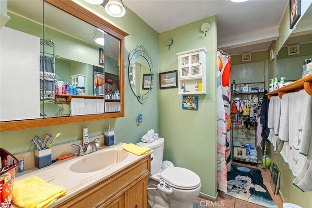 full bathroom featuring toilet, vanity, tile patterned floors, and a shower with shower curtain