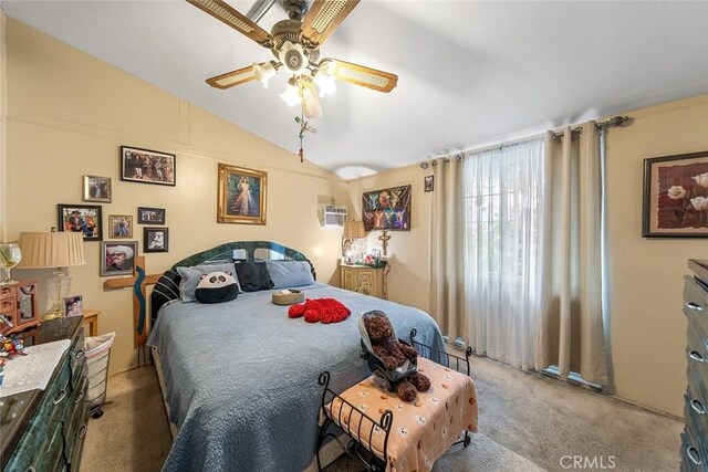 carpeted bedroom with vaulted ceiling and a ceiling fan