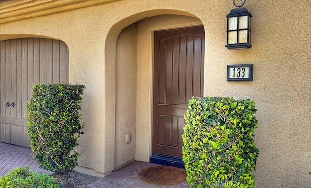doorway to property with stucco siding