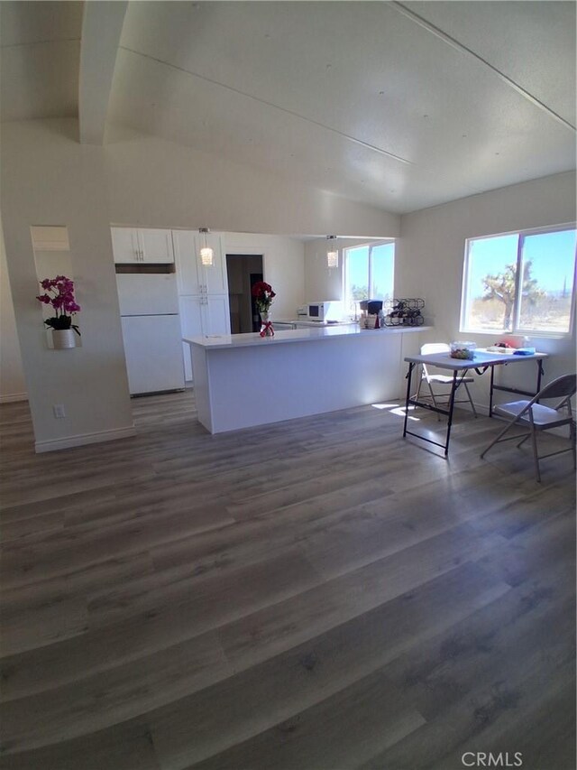 4626 Duncan Rd, Phelan, CA 92371 - kitchen with freestanding refrigerator, white cabinetry, wood finished floors, a peninsula, and vaulted ceiling