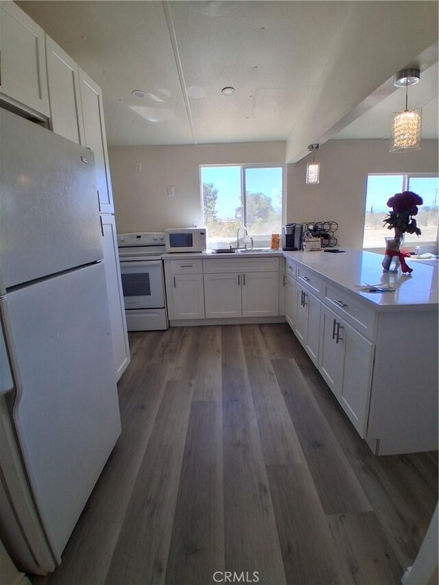 4626 Duncan Rd, Phelan, CA 92371 - kitchen with white appliances, a sink, white cabinets, and plenty of natural light