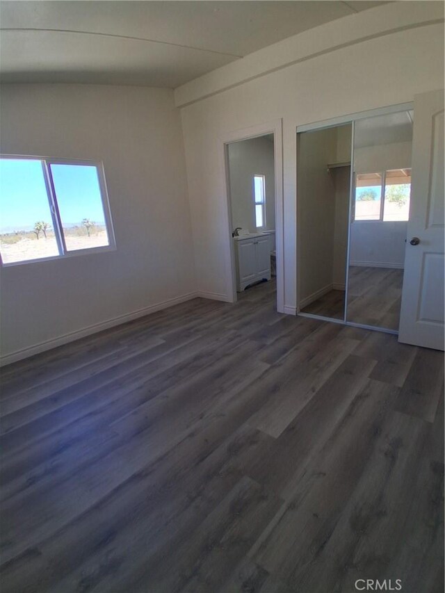4626 Duncan Rd, Phelan, CA 92371 - unfurnished bedroom featuring baseboards, wood finished floors, multiple windows, and a closet