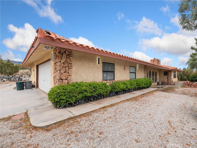 1275 Tamarack Rd, Pinon Hills, CA 92372 - ranch-style home with stucco siding, a tiled roof, a chimney, and an attached garage