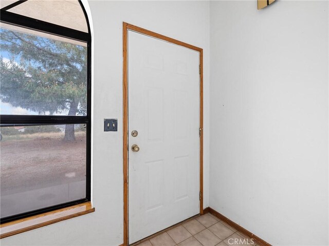 1275 Tamarack Rd, Pinon Hills, CA 92372 - doorway with light tile patterned flooring and baseboards