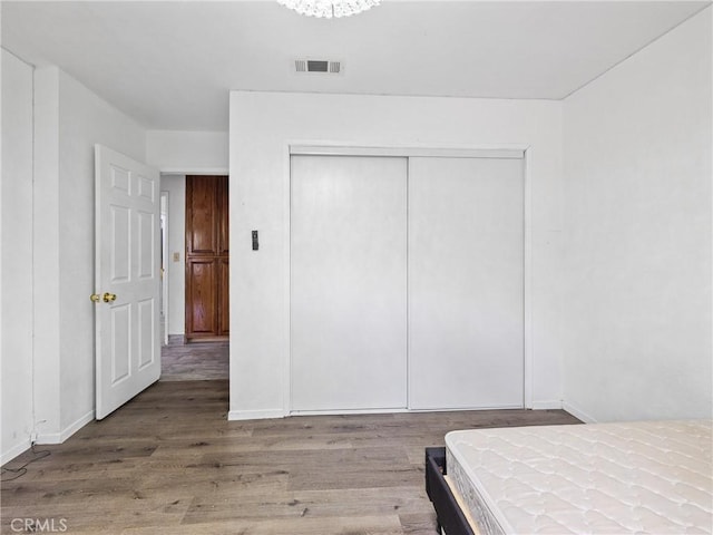1275 Tamarack Rd, Pinon Hills, CA 92372 - bedroom with wood finished floors, a closet, and baseboards