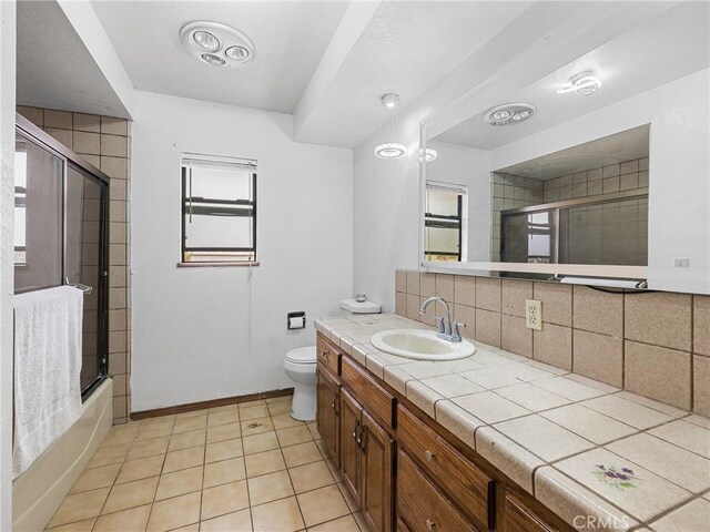 1275 Tamarack Rd, Pinon Hills, CA 92372 - bathroom featuring toilet, tasteful backsplash, vanity, bath / shower combo with glass door, and tile patterned floors
