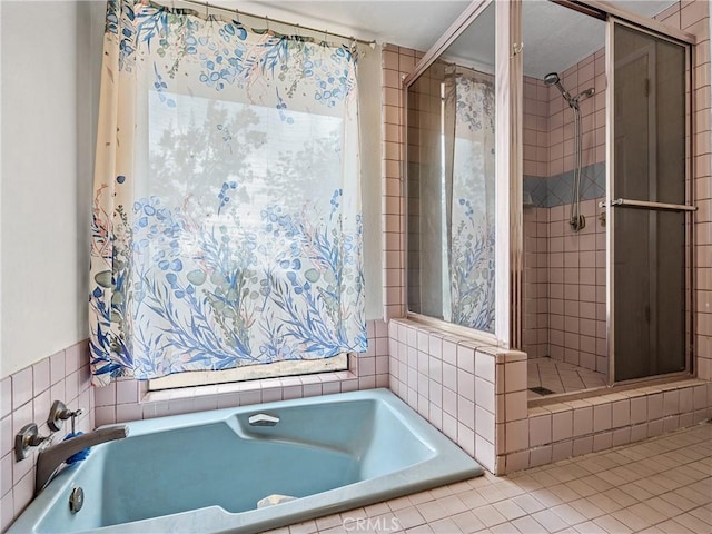 1275 Tamarack Rd, Pinon Hills, CA 92372 - bathroom with a shower stall, a garden tub, tile patterned flooring, and tile walls
