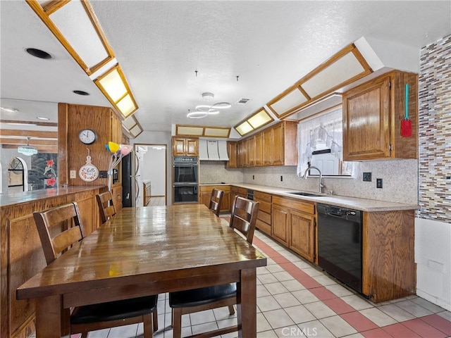 1275 Tamarack Rd, Pinon Hills, CA 92372 - kitchen featuring black appliances, a sink, light countertops, light tile patterned floors, and backsplash