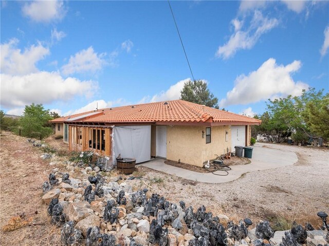 1275 Tamarack Rd, Pinon Hills, CA 92372 - rear view of house with a tiled roof and stucco siding