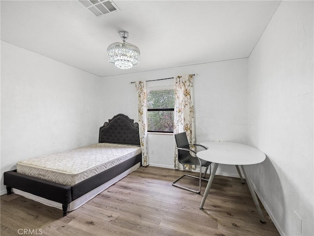 1275 Tamarack Rd, Pinon Hills, CA 92372 - bedroom featuring wood finished floors, baseboards, and a chandelier