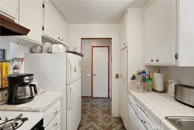 6255 Woodman Ave Unit 103, Van Nuys, CA 91401 - kitchen featuring tile counters, white cabinets, range with gas cooktop, and freestanding refrigerator