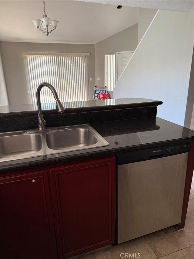 kitchen featuring dark brown cabinets, a sink, dishwasher, dark countertops, and vaulted ceiling
