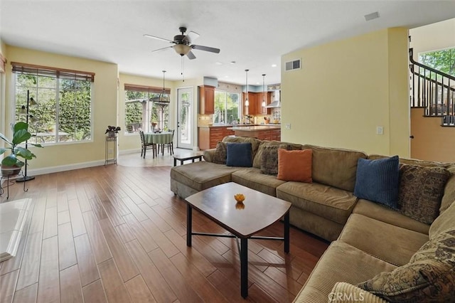 23405 Winslow Pl, Valencia, CA 91354 - living area featuring ceiling fan, plenty of natural light, wood finished floors, and stairway