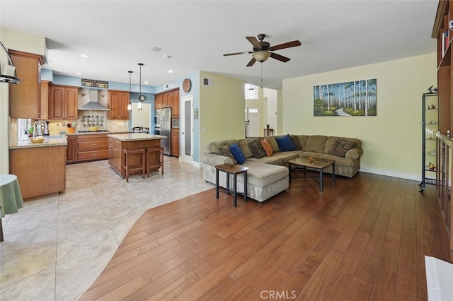 23405 Winslow Pl, Valencia, CA 91354 - living area featuring a ceiling fan, baseboards, light wood-style floors, and recessed lighting