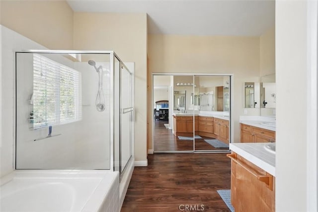 23405 Winslow Pl, Valencia, CA 91354 - bathroom featuring a stall shower, wood finished floors, vanity, and a tub to relax in