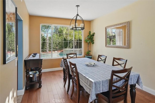 23405 Winslow Pl, Valencia, CA 91354 - dining space featuring baseboards, wood finished floors, and a chandelier