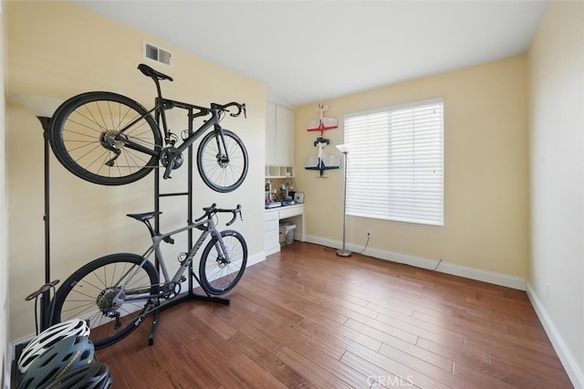 23405 Winslow Pl, Valencia, CA 91354 - workout room featuring wood finished floors and baseboards