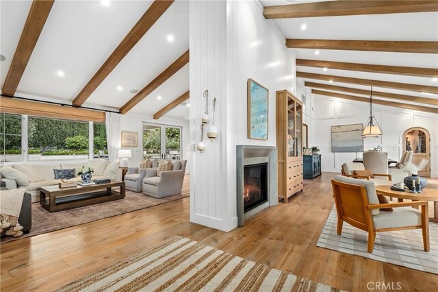 living area featuring a glass covered fireplace and light wood-type flooring